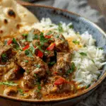 Fiery Beef Coconut Curry with Rice, Garlic Naan & Chili Garnish