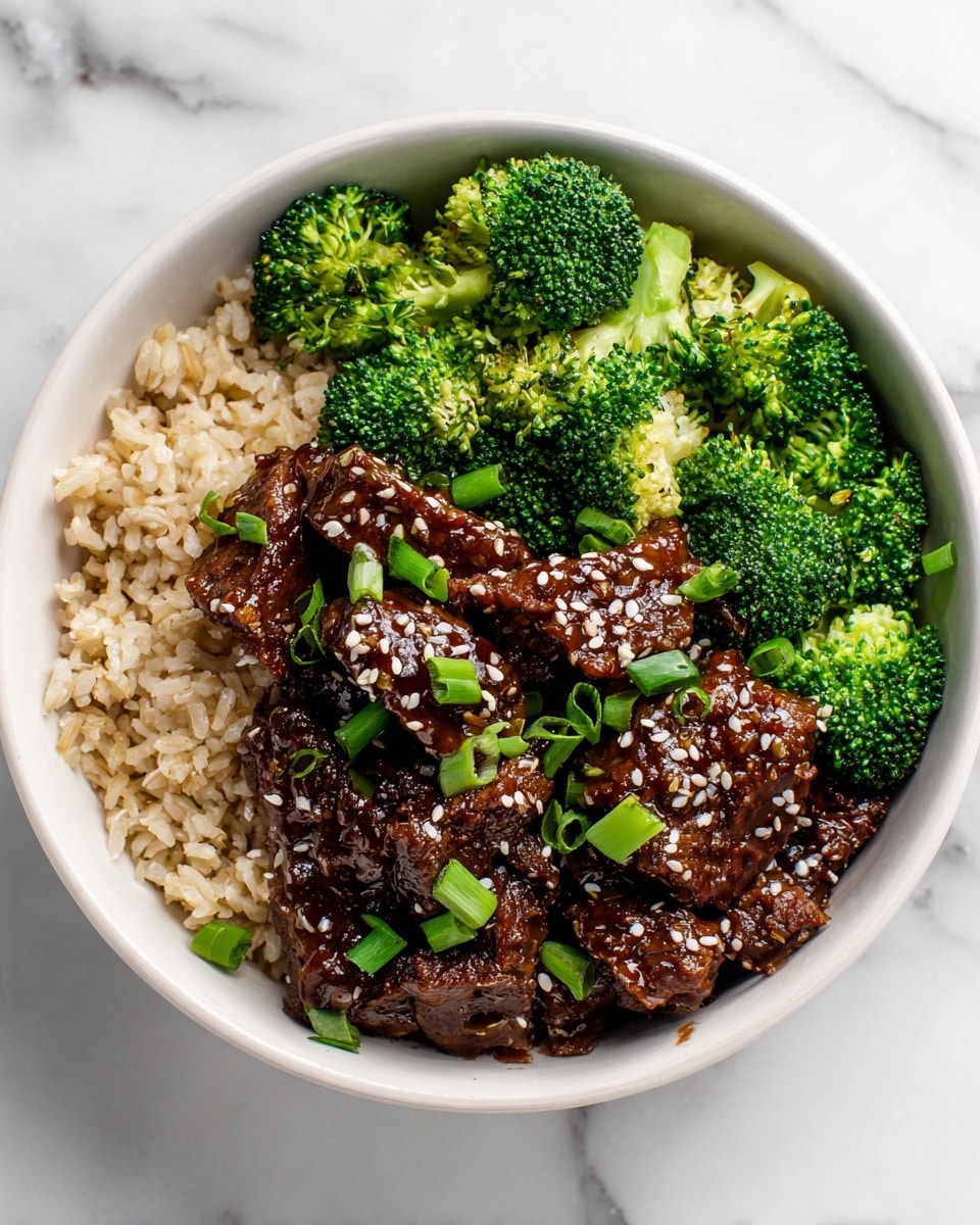 A white bowl filled with three main layers: the bottom layer is light brown rice with a slightly fluffy texture, the middle layer consists of vibrant green broccoli florets, some with visible small stems, and the top layer features dark brown glazed beef slices covered in shiny sauce sprinkled with white sesame seeds and small chopped green onions. The bowl sits on a white marbled surface, and the whole dish looks fresh and colorful. photo taken with an iphone --ar 4:5 --v 7