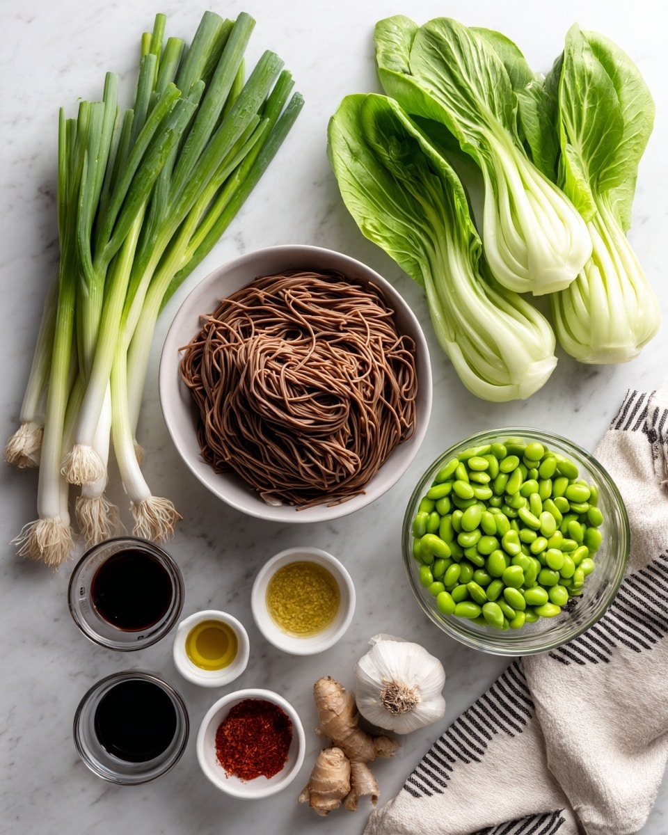 The image shows an arrangement of fresh cooking ingredients on a white marbled surface. On the left, there are long green onions with white bases. To their right, two fresh light green bok choy lay side by side. In the center, a clear white bowl is filled with brown flat noodles. Below it, another clear white bowl holds green frozen edamame beans. Around these bowls, small clear white ramekins contain dark soy sauce, light water, golden oil, light brown paste, red chili oil, and a piece of fresh ginger root next to a whole white garlic bulb. At the bottom right corner, a beige cloth with black stripes is partially visible. Photo taken with an iphone --ar 4:5 --v 7