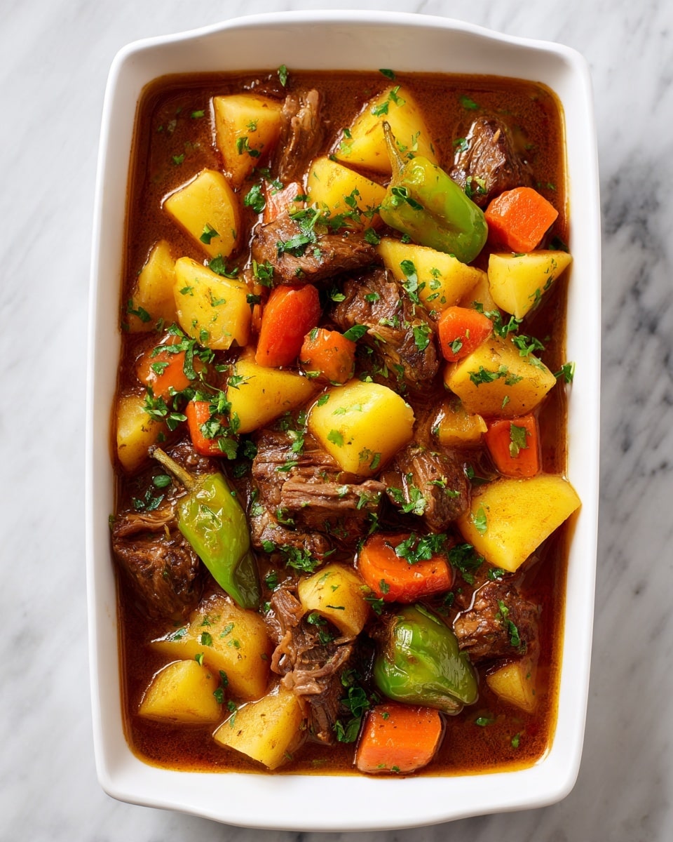 A white rectangular dish filled with a stew showing three main layers: the bottom layer is a thick, brown gravy; scattered on top are chunks of light yellow potatoes with red skins, bright orange carrot pieces, and darker brown shredded meat mixed evenly throughout; three whole yellow-green peppers sit on top, adding contrast; the dish is sprinkled lightly with green herbs; the background is a white marbled surface. photo taken with an iphone --ar 4:5 --v 7