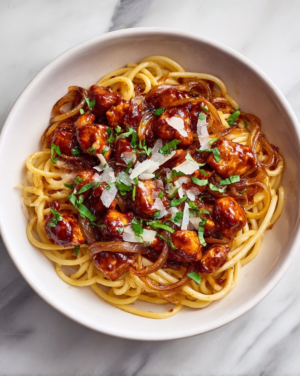 A white bowl filled with spaghetti pasta, coated in a rich red tomato sauce with visible caramelized onion slices. On top, there are small brown pieces of cooked meat scattered evenly. Fresh green parsley leaves are sprinkled across the dish along with a light dusting of grated white cheese. The pasta strands and ingredients show a shiny, slightly glossy texture. The bowl is placed on a white marbled surface. Photo taken with an iphone --ar 4:5 --v 7