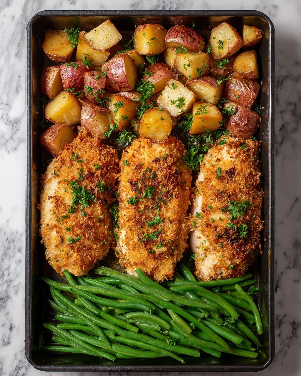 The image shows a large baking tray filled with three main layers of food arranged vertically: the top layer has golden-brown roasted potatoes with red skins, cut into chunks and scattered unevenly; the middle layer features three pieces of baked chicken covered in a crispy, light golden breadcrumb coating sprinkled with small green herbs; the bottom layer has a neat row of bright green cooked green beans that look tender and slightly glossy. The tray itself is gold-colored and rests on a white marbled surface. photo taken with an iphone --ar 4:5 --v 7