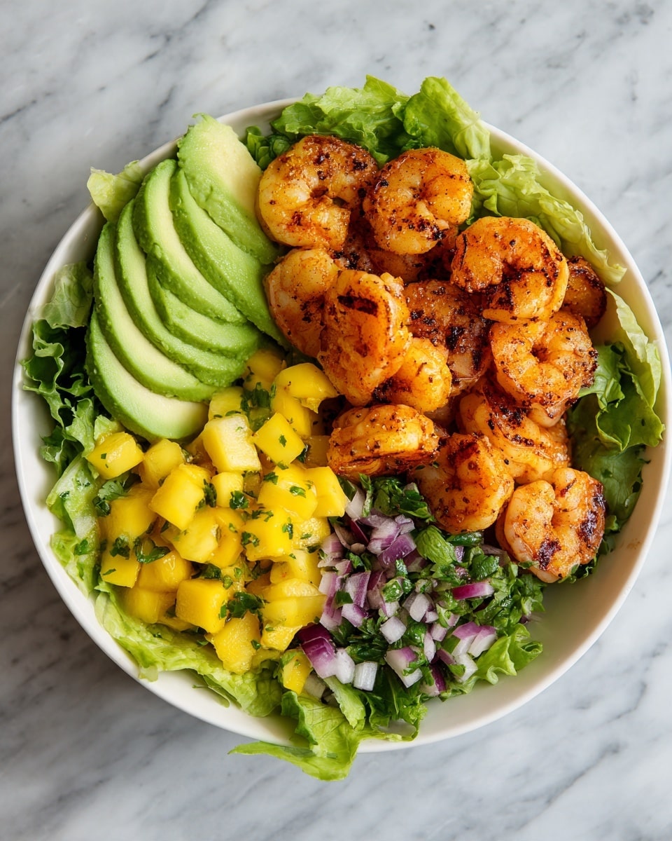 A round bowl with a speckled pattern holds a colorful layered shrimp salad. The bottom layer is bright green leafy lettuce. On the right side, there are well-seasoned, grilled shrimp with a slightly charred orange and brown color arranged in a curved line. On the left, neat slices of ripe avocado with light green and creamy yellow colors are fanned out. At the bottom center, a mix of diced yellow mango, green herbs, and small pieces of red onion creates a fresh and vibrant contrast. The bowl sits on a white marbled surface. Photo taken with an iphone --ar 4:5 --v 7